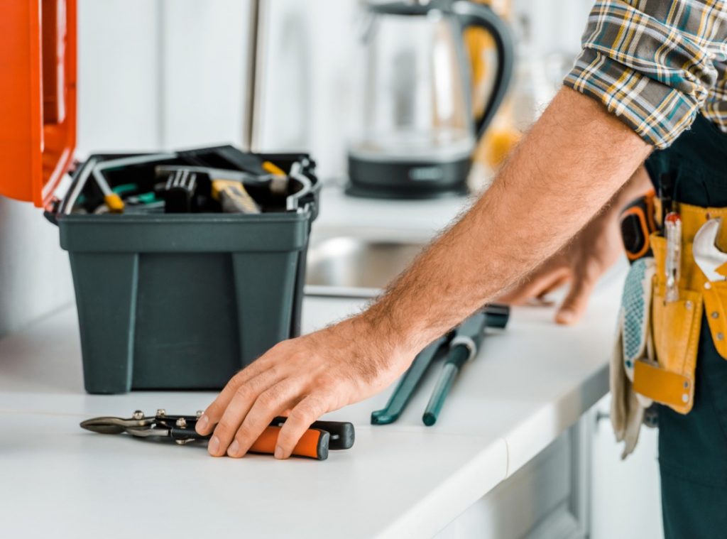 man working with tools on a tool bench