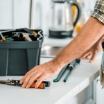 man working with tools on a tool bench