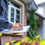 home inspector checking the exterior of a home